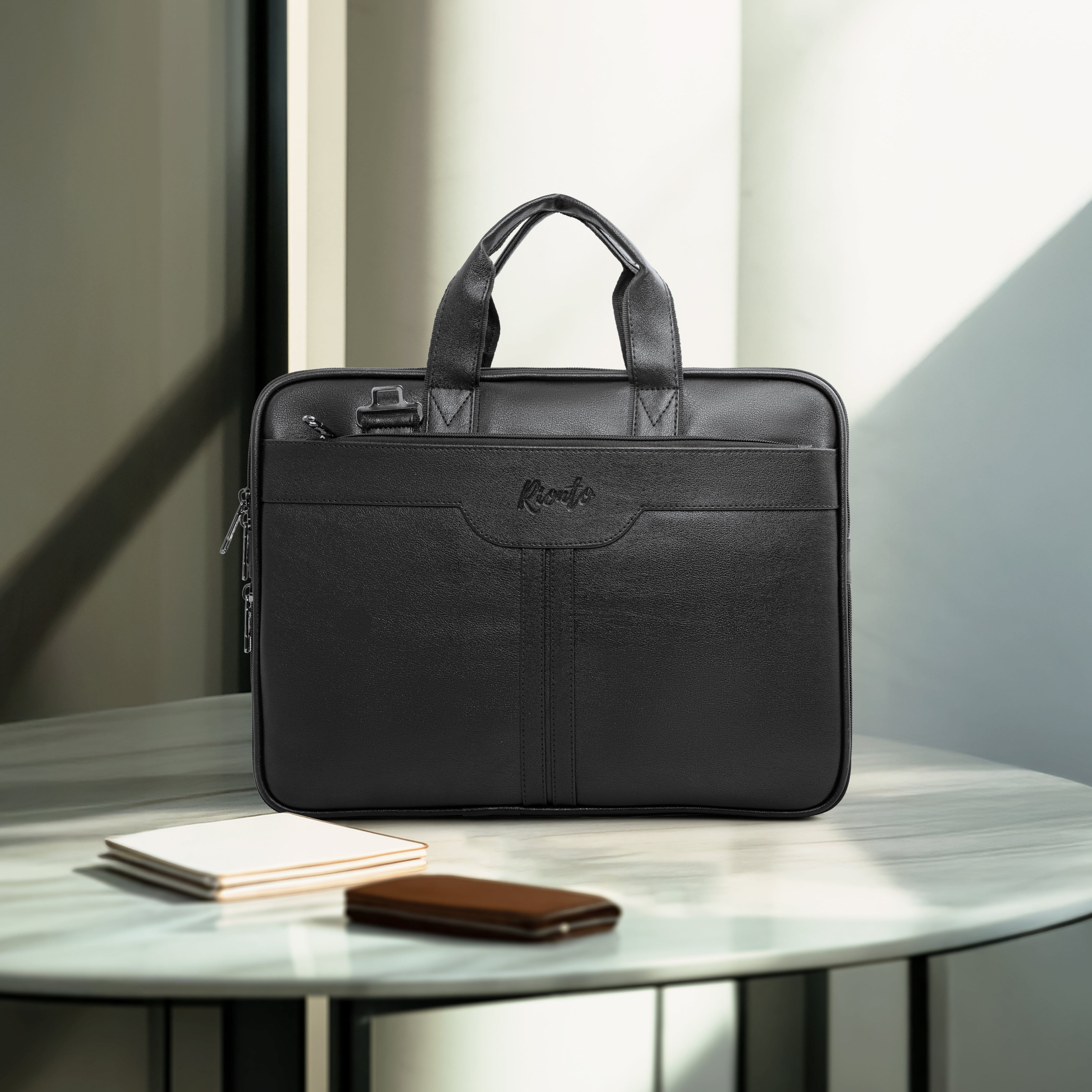 Black leather briefcase on a round table with a minimal background